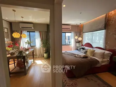 Luxurious bedroom with elegant decor and adjacent dining area, featuring natural light and stylish furnishings.