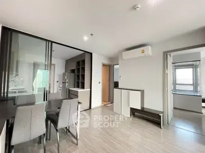 Modern apartment interior with dining area and air conditioning, featuring sleek design and natural light.