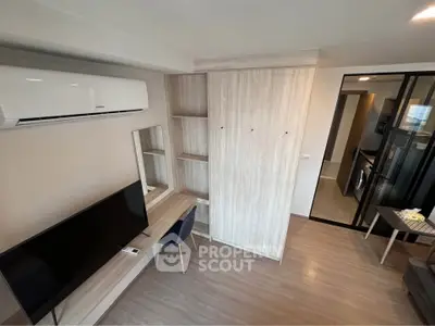 Modern living room with sleek furniture and built-in storage in a stylish apartment.