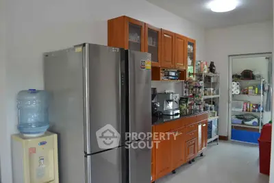 Modern kitchen with stainless steel fridge and wooden cabinets