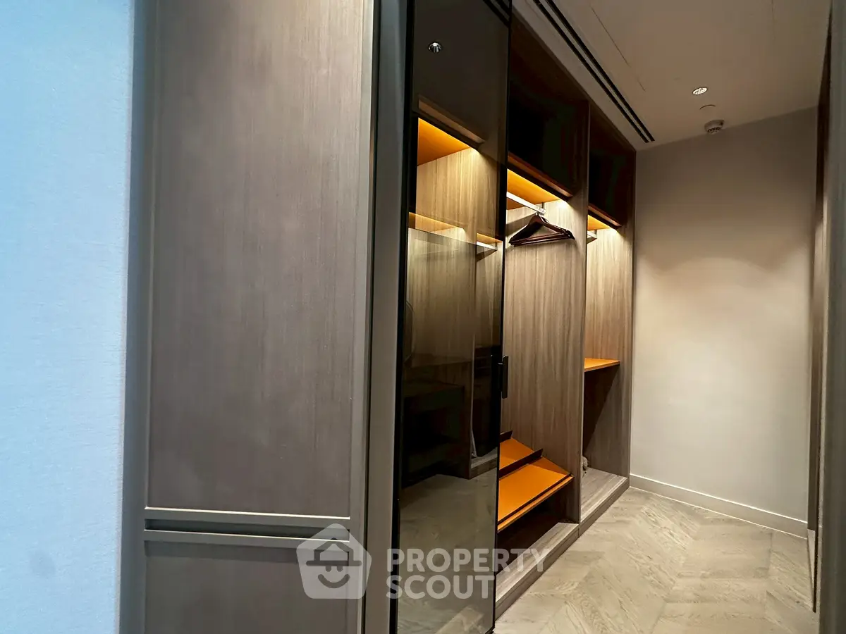 Luxurious walk-in closet with modern design and ample storage space.