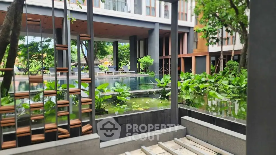 Luxurious modern building with serene garden and water feature, perfect for relaxation and tranquility.