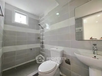 Modern bathroom with sleek fixtures and contemporary tile design.