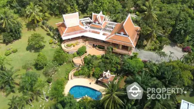 Stunning aerial view of luxurious tropical villa with lush gardens and private pool