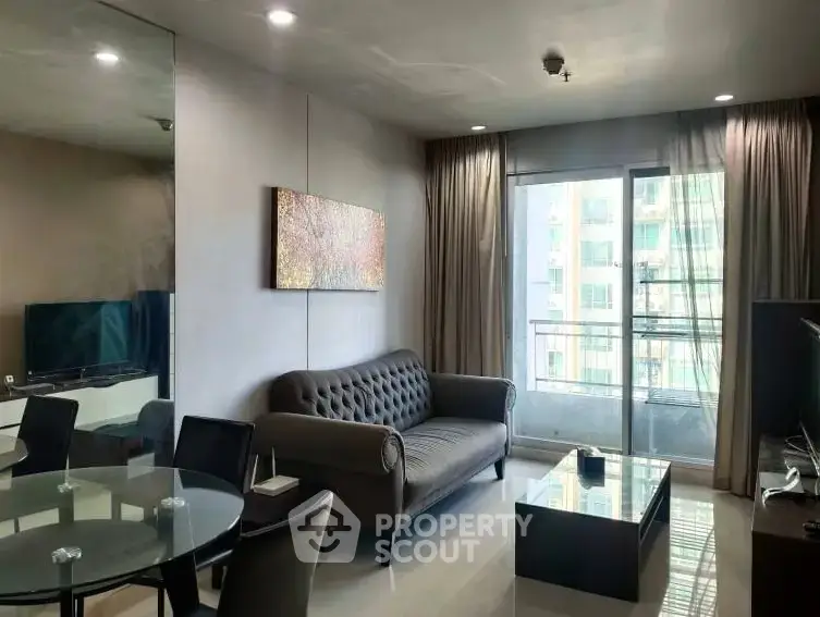 Modern living room with elegant decor and balcony view in a stylish apartment.