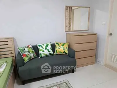 Cozy living room with stylish sofa and vibrant cushions in modern apartment.