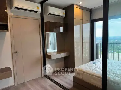 Modern bedroom with balcony view, featuring sleek design and ample natural light.