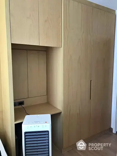 Modern wooden storage unit with integrated desk and air purifier in compact space