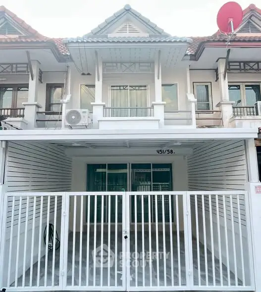 Charming townhouse with gated entrance and balcony in a serene neighborhood.