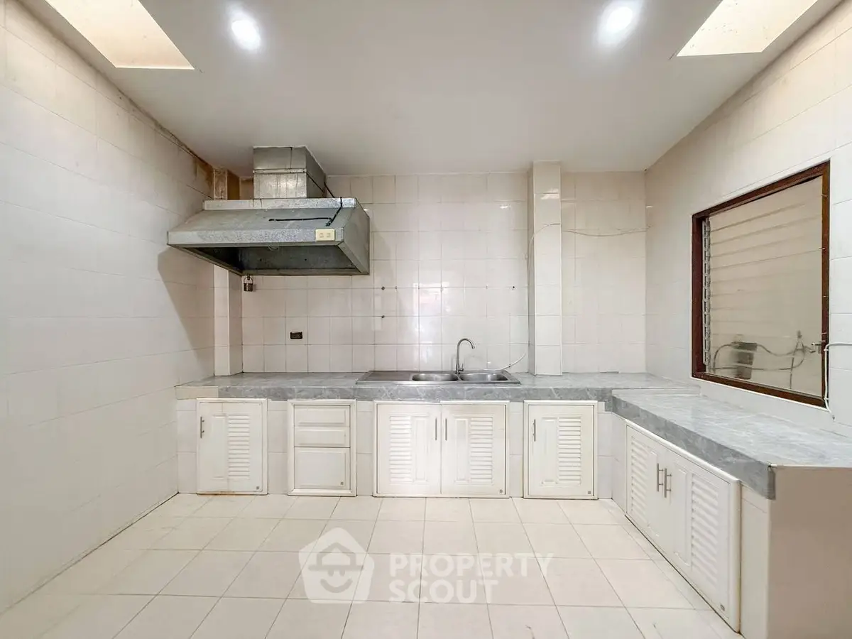 Spacious kitchen with modern cabinetry and sleek countertops, perfect for culinary enthusiasts.