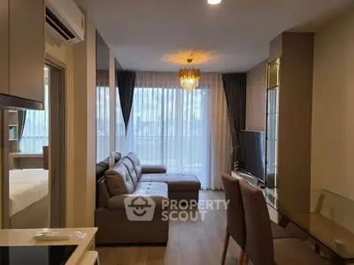 Modern living room with elegant decor and large windows in a stylish apartment.