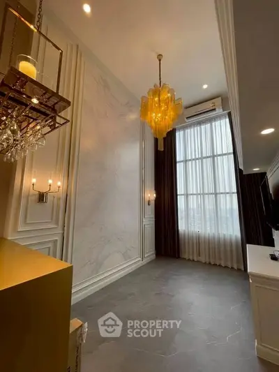 Luxurious living room with high ceilings and elegant chandeliers