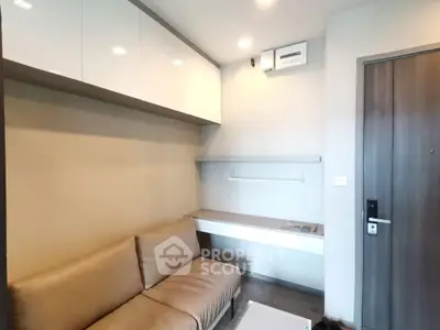 Modern living room with sleek design and cozy seating in a compact space.