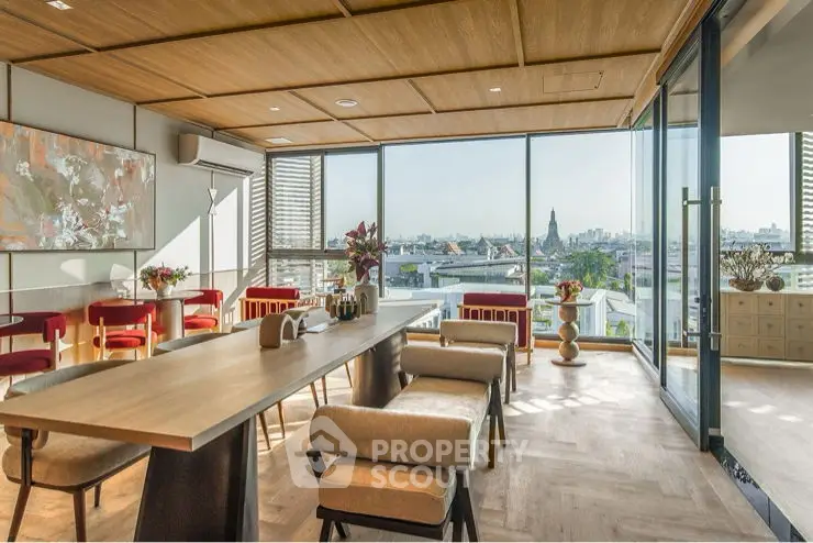 Luxurious modern living room with panoramic city views and stylish decor.