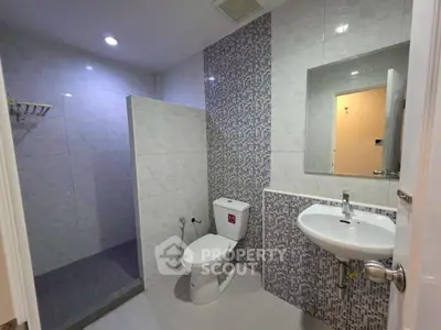 Modern bathroom with sleek tiles and walk-in shower