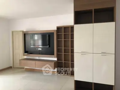 Modern living room with sleek TV unit and ample storage space