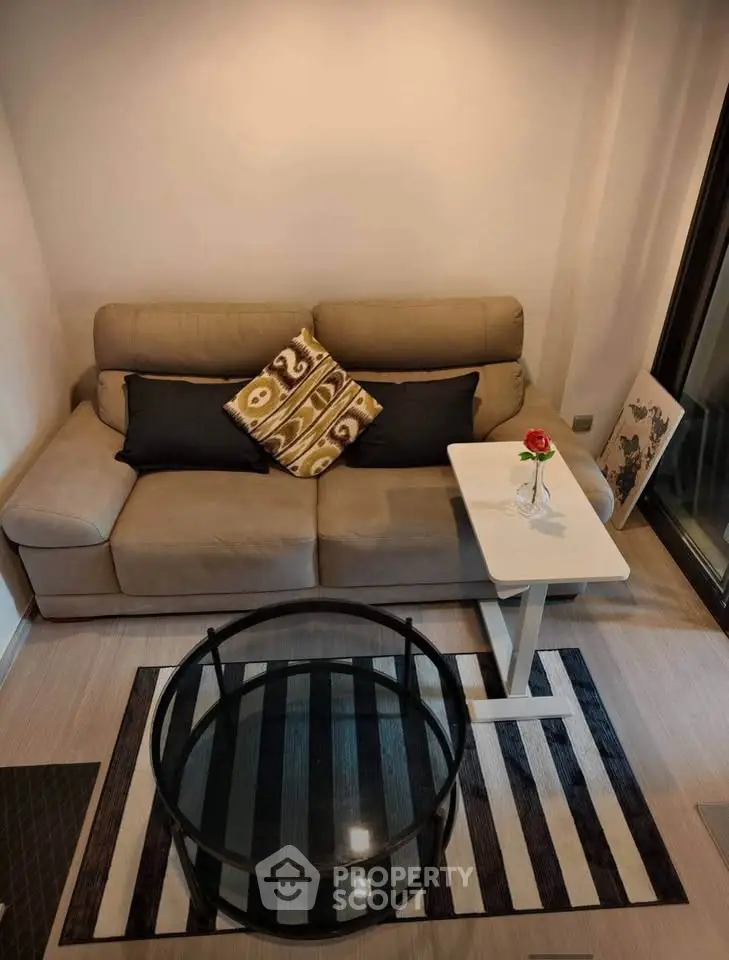 Cozy living room with modern sofa and stylish decor in a contemporary apartment.