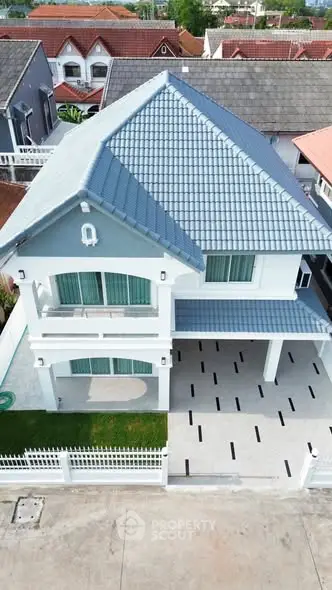 Stunning two-story house with modern design and spacious driveway in a serene neighborhood.