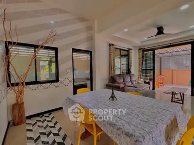 Spacious dining and living area with modern decor and outdoor access