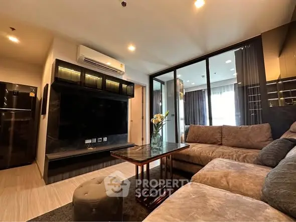 Modern living room with plush sofa and large TV in stylish apartment