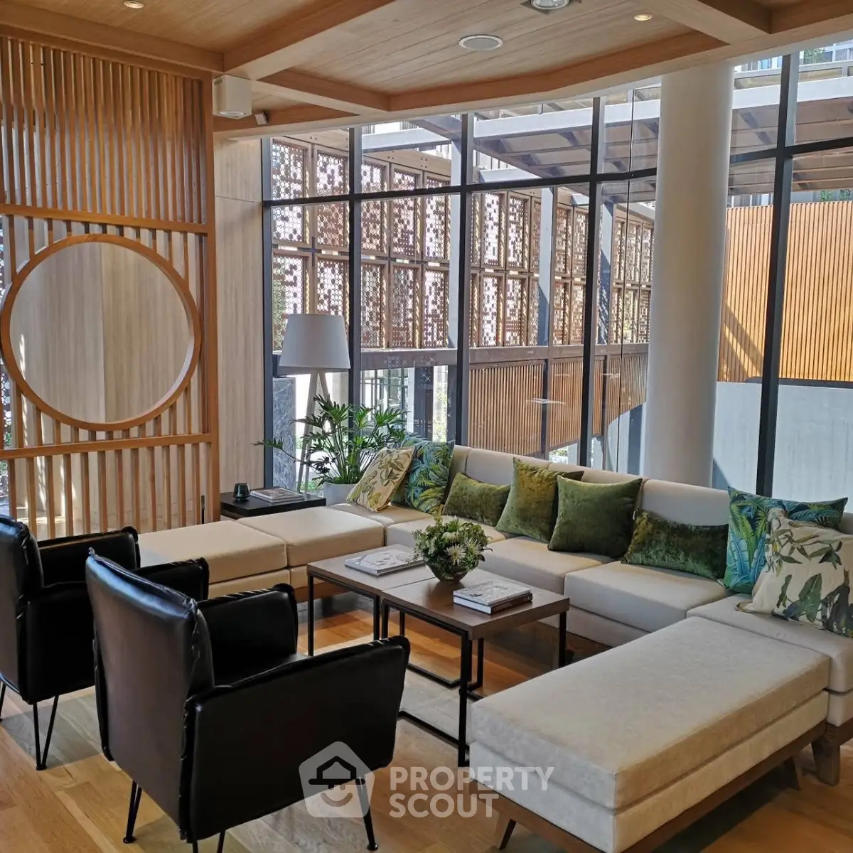 Modern living room with stylish decor and large windows offering natural light.