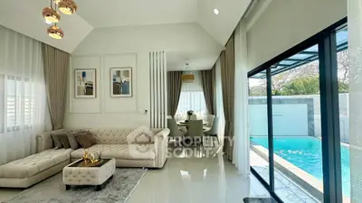 Luxurious living room with pool view, elegant decor, and modern furnishings