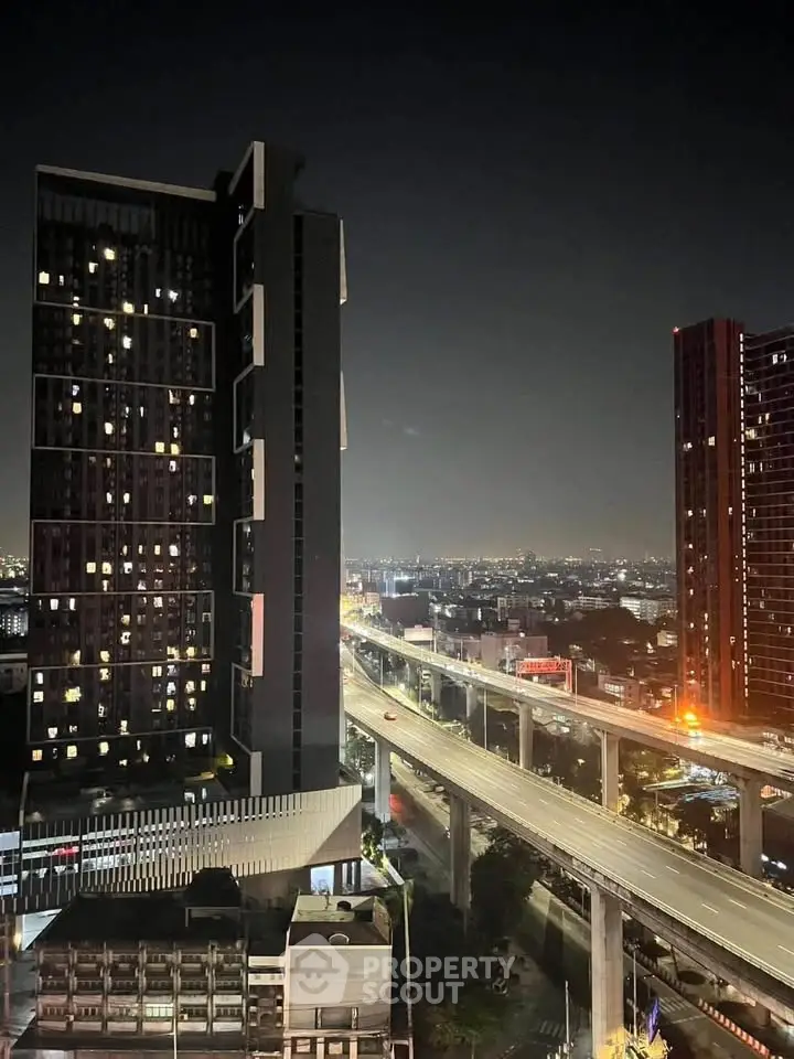 Stunning night view of modern high-rise buildings and cityscape with illuminated roads.