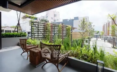 Charming balcony with lush greenery and stylish seating, offering a serene outdoor retreat.