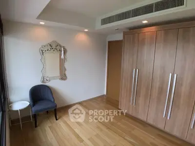 Spacious bedroom with elegant wooden wardrobe and stylish decor
