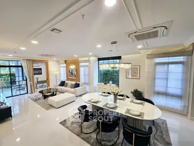 Luxurious open-plan living and dining area with elegant decor and ample natural light.