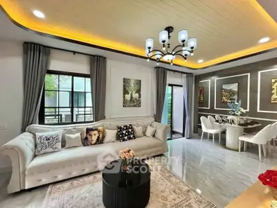 Luxurious living room with elegant decor and modern lighting, featuring a spacious layout and stylish furniture.
