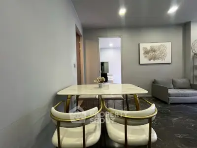 Modern dining area with elegant marble table and stylish chairs in a cozy living room setting.