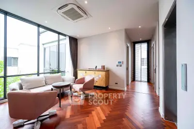 Modern living room with stylish furniture and large windows offering natural light.