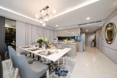Luxurious open-plan dining and kitchen area with modern decor and elegant lighting.