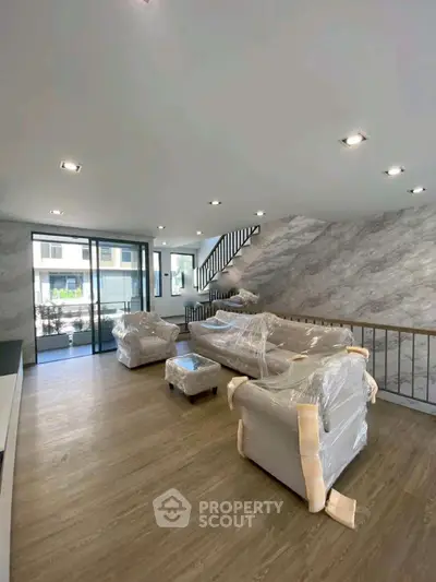 Spacious modern living room with large windows and stylish decor in a contemporary home.