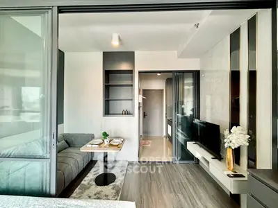 Modern living room with sleek design and open layout, featuring a cozy sofa and wall-mounted TV.