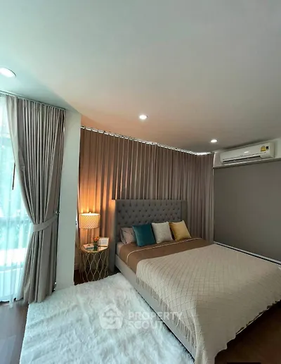 Luxurious bedroom with elegant decor and natural light, featuring a plush bed and stylish curtains.