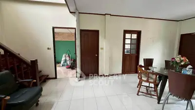 Spacious living room with dining area and staircase in a cozy home