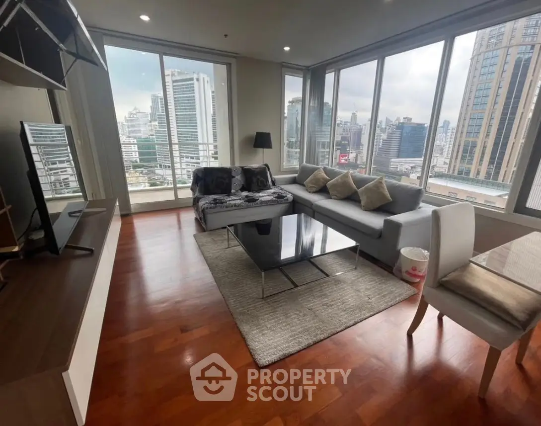 Spacious corner unit living room with stunning city view and modern furnishings.