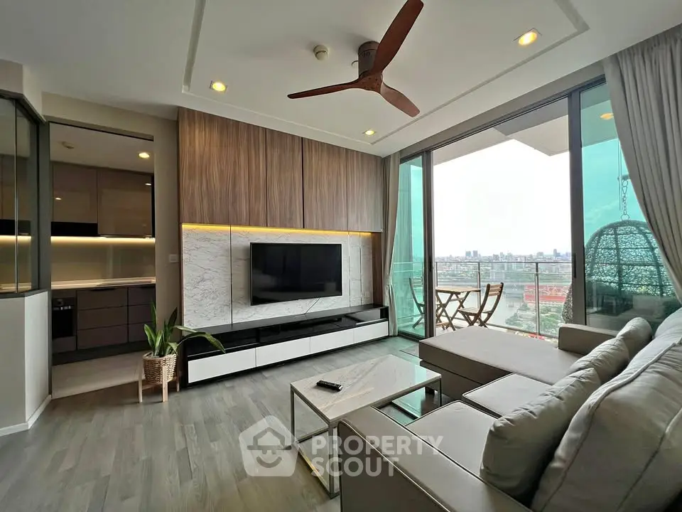 Modern living room with balcony and city view, featuring stylish decor and open layout.