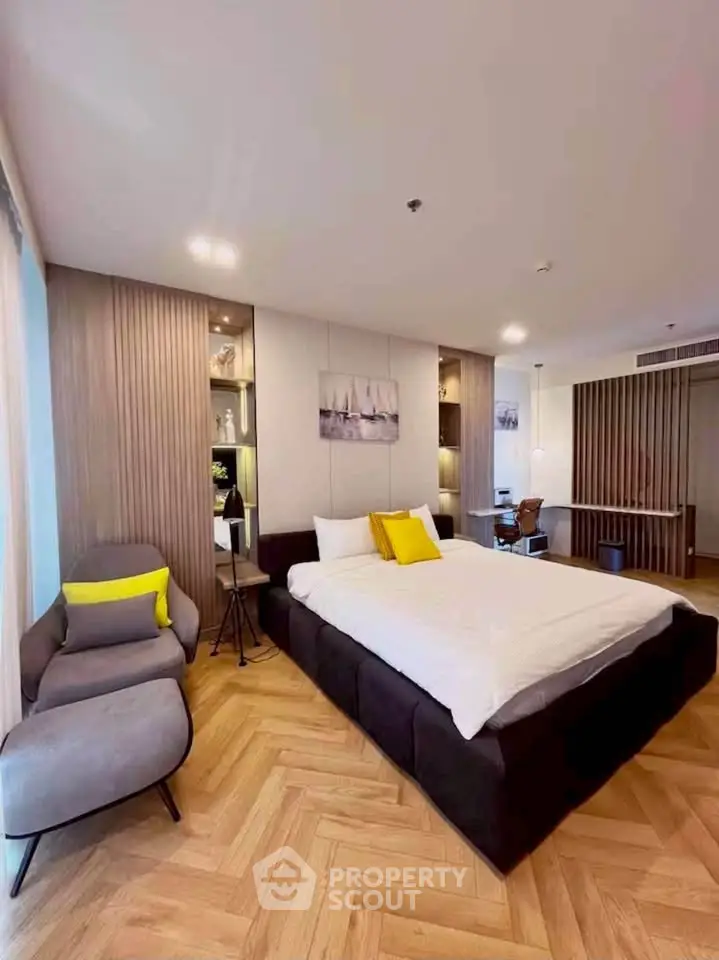 Luxurious modern bedroom with stylish decor and cozy seating area, perfect for relaxation and comfort.