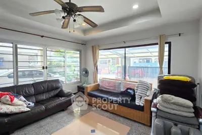 Spacious living room with large windows and comfortable seating