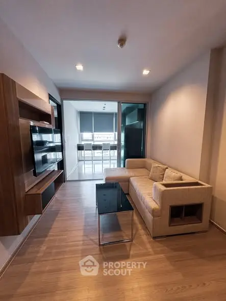 Modern living room with sleek furniture and open balcony view