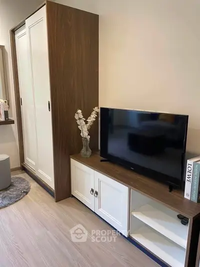 Modern living room with sleek TV stand and stylish wardrobe, perfect for contemporary urban living.