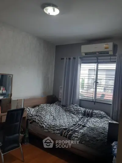 Cozy bedroom with air conditioning and natural light from window