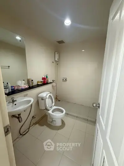Spacious bathroom with modern fixtures and ample storage space.