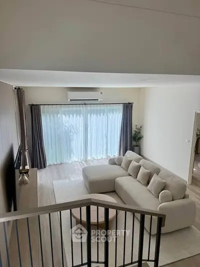 Spacious modern living room with elegant decor and large windows