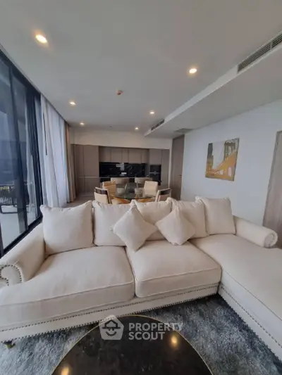 Luxurious living room with elegant sofa and dining area in modern apartment