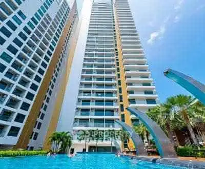 Luxurious high-rise building with stunning pool and palm trees, perfect for modern urban living.
