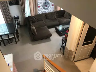 Spacious living room with plush sectional sofa and dining area, perfect for family gatherings.